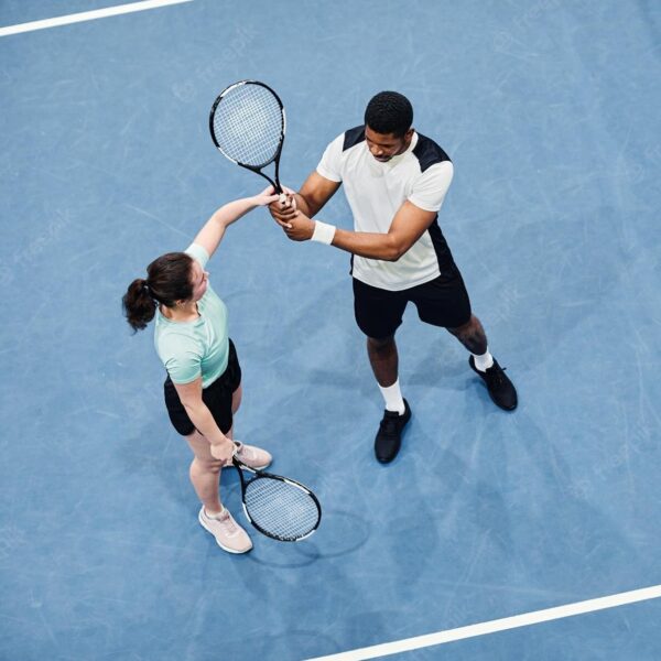 minimal-top-view-tennis-coach-working-with-client-against-vibrant-blue-court-copy-space_236854-39290